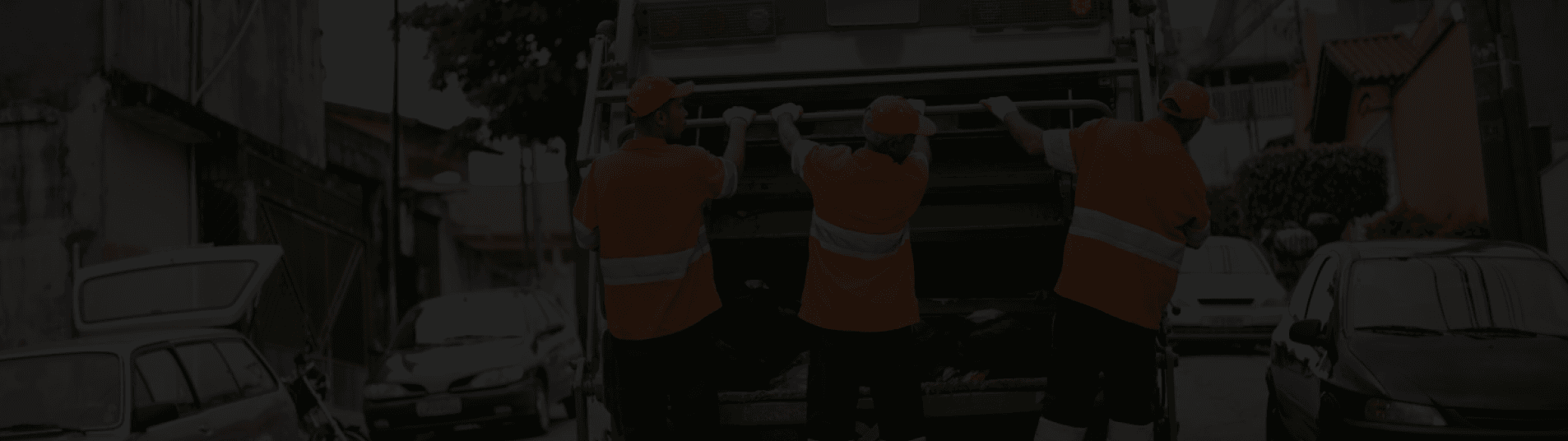 Waste collection crew in hi-vis loading a collection truck