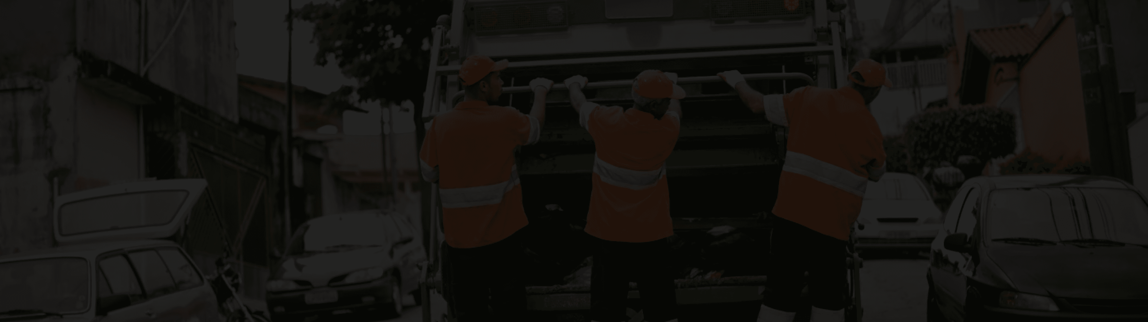 Waste collection crew in hi-vis loading a collection truck